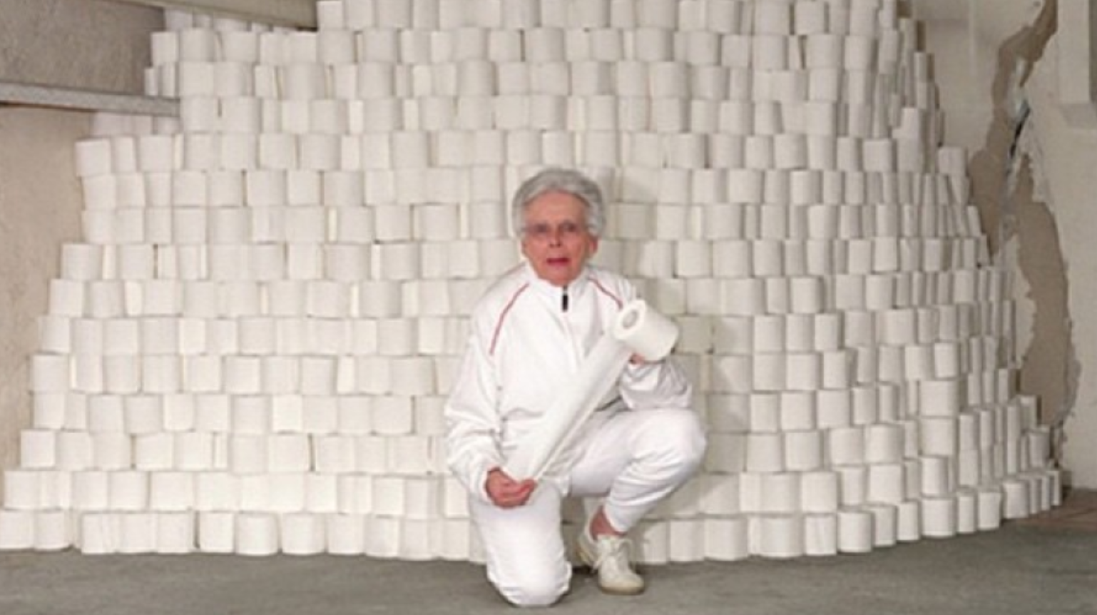 grandma crouching in front of a huge pile of toilet paper for zoom virtual background