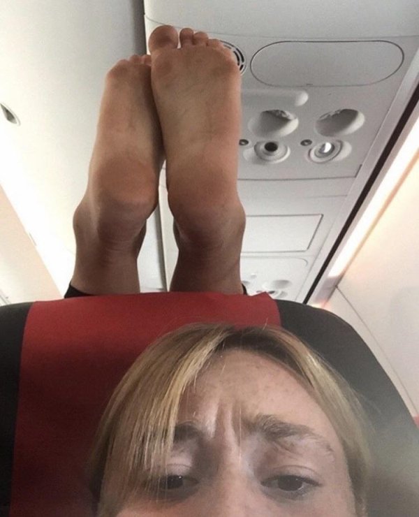 feet on airplane headrest