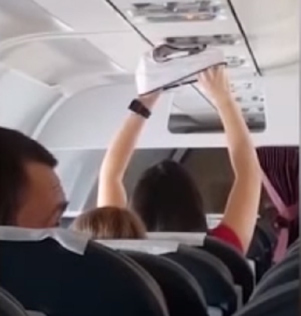 lady drying underwear airplane