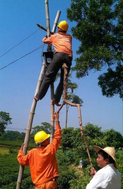 three men bootleg stick ladder electric workers