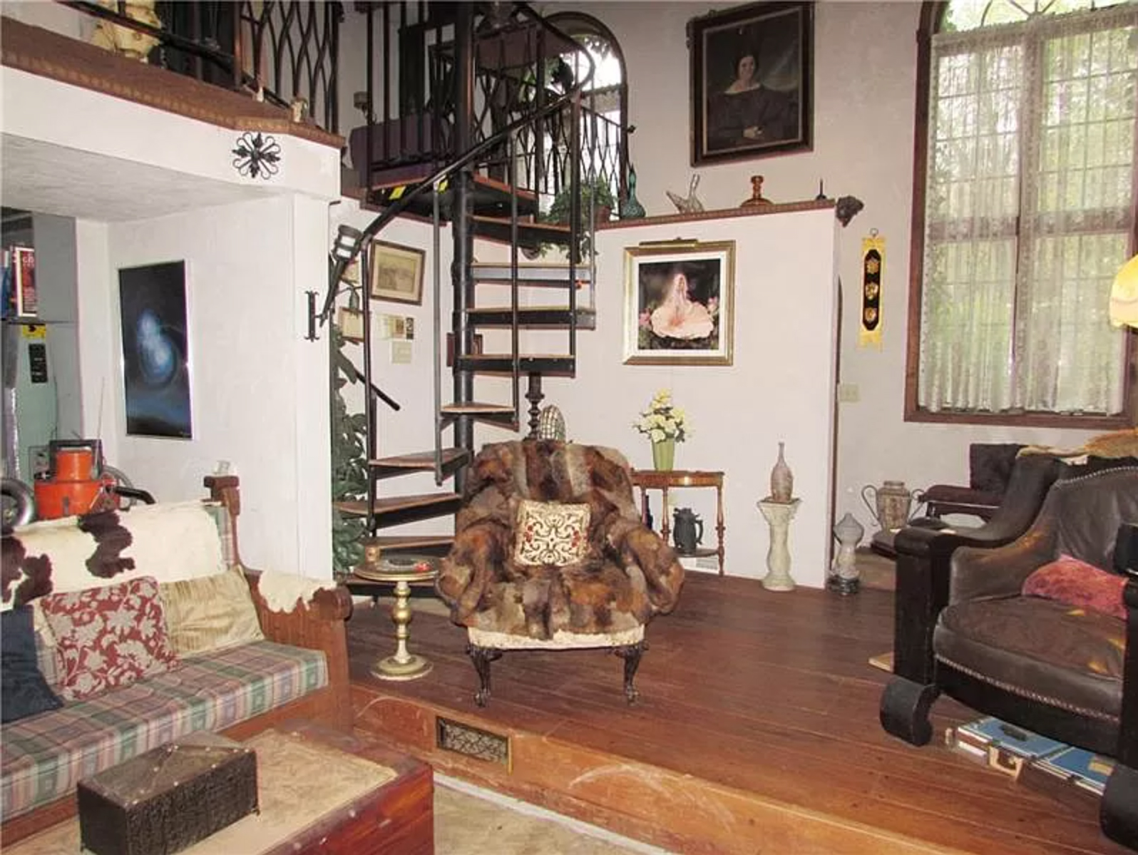 house with weird leather chair and spiral staircase