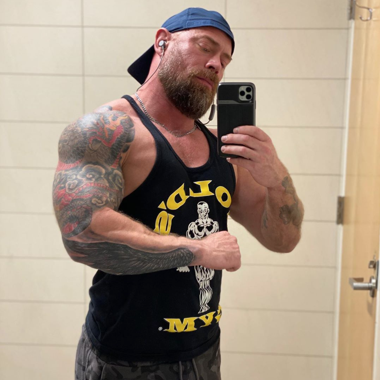 Mike Shultz flexing in a tank top before getting COVID-19