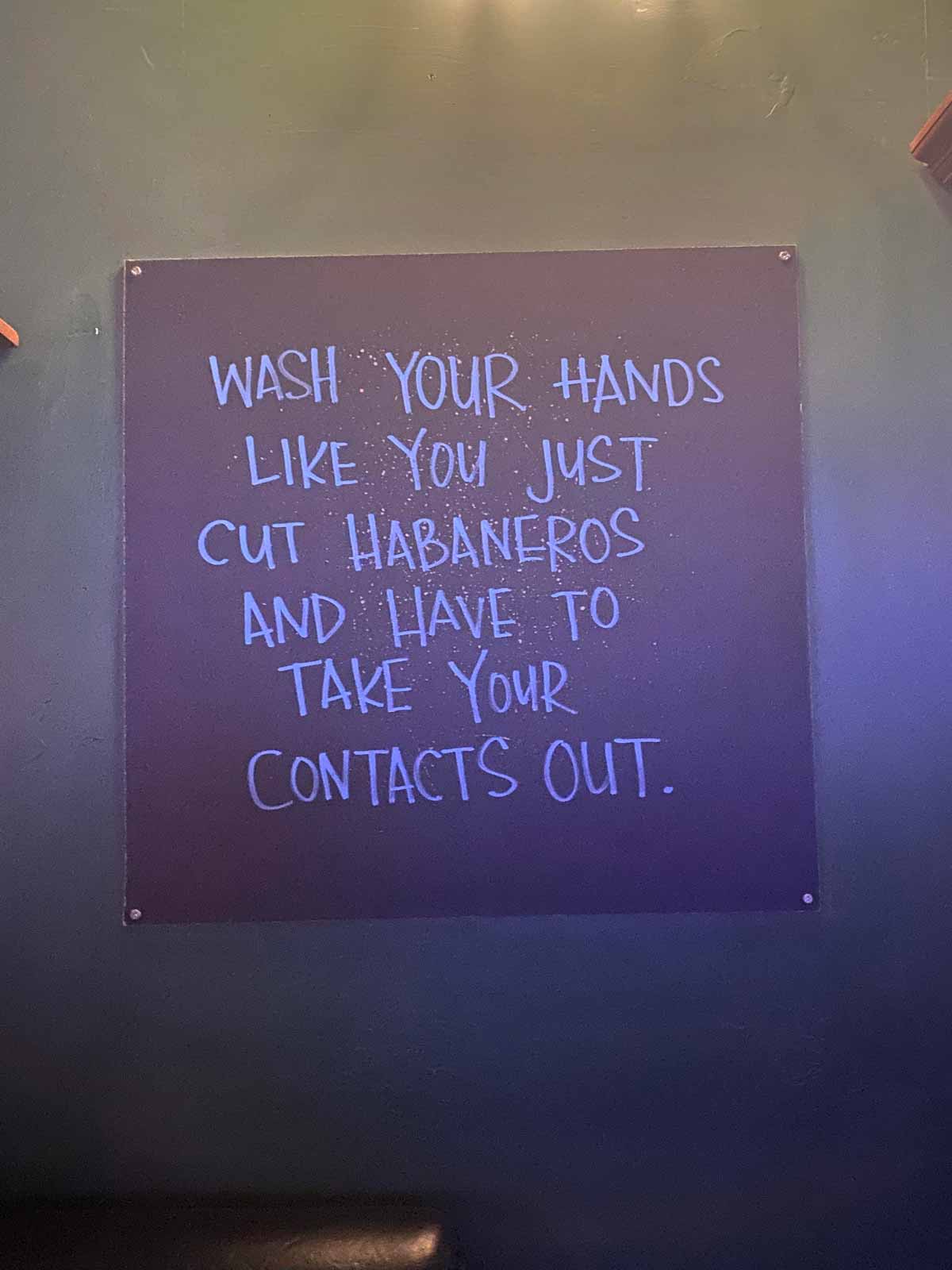 Funny bathroom sign that says 'wash your hands like you just cut habanero and have to take your contacts out'