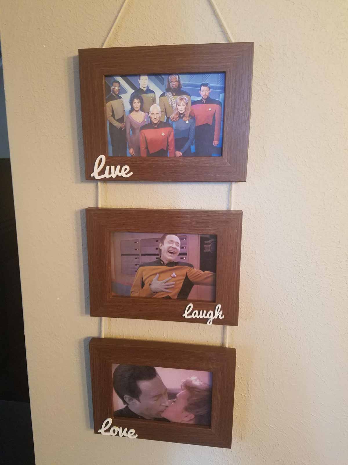 A hanging Live Laugh Love sign in a home where data from Star Trek TNG is in each of the frames