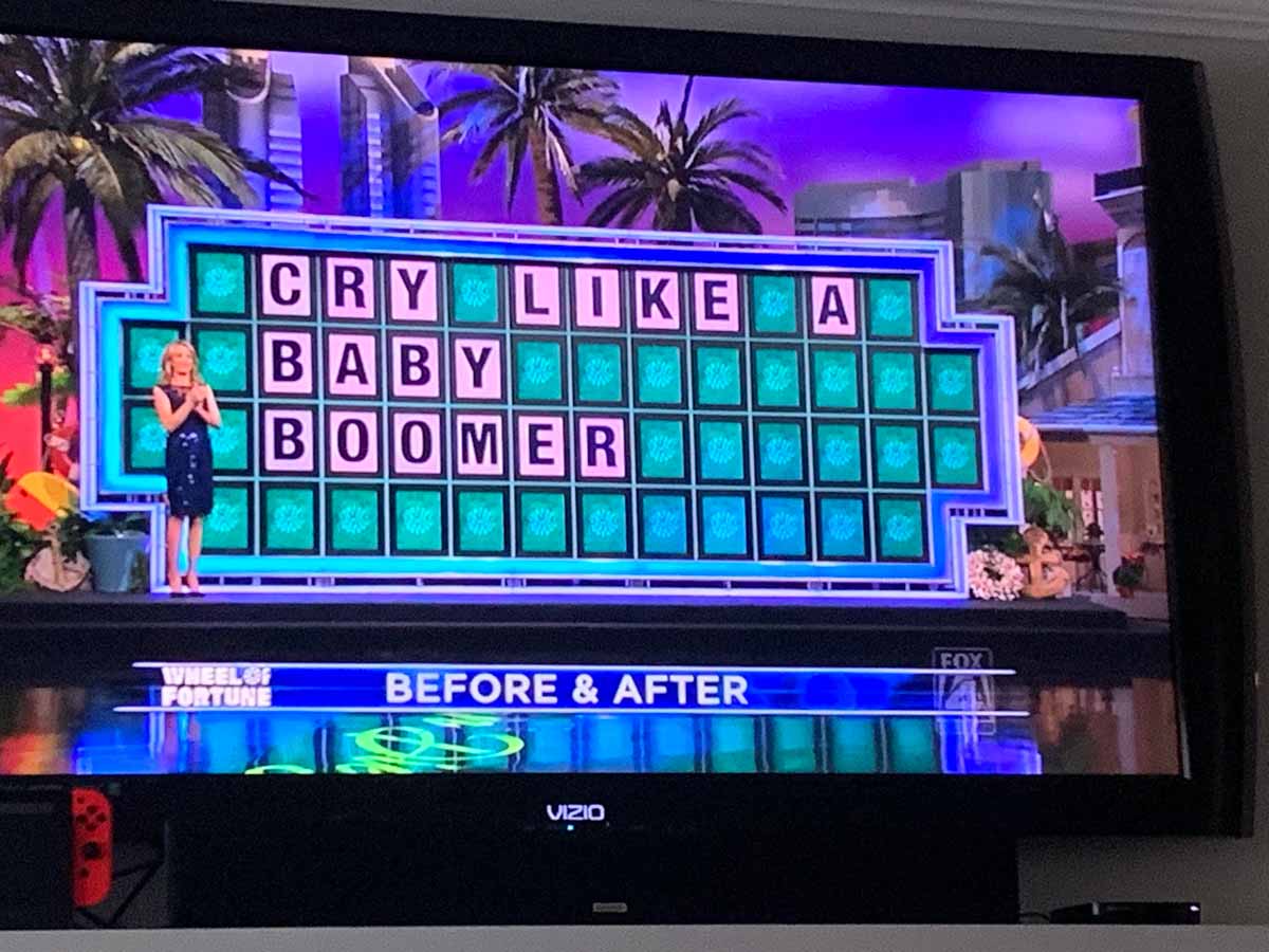 Funny picture of a tv with Wheel of Fortune on and the answer to the puzzle was 'Cry like a baby boomer'