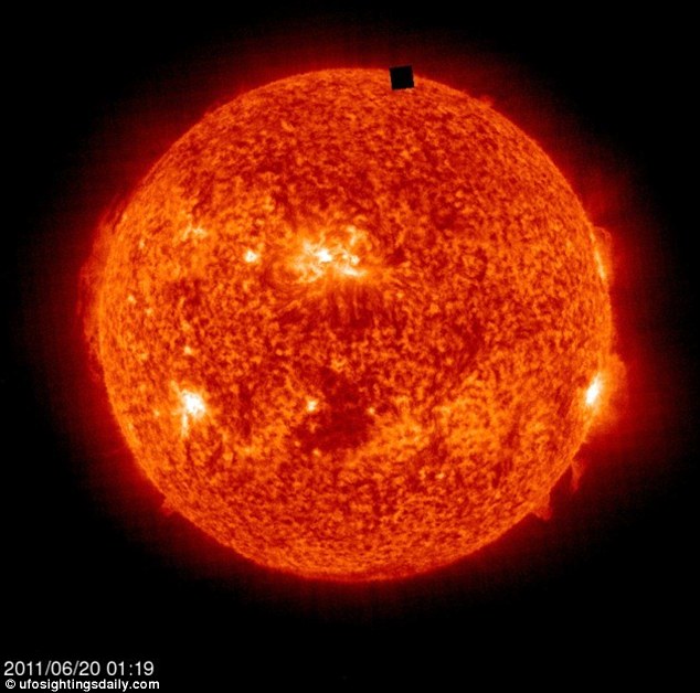 red image of the sun with the "black alien space cube"