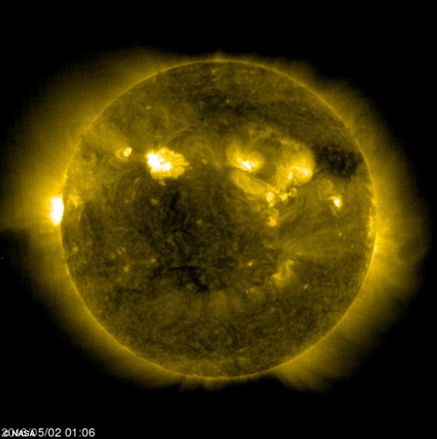yellow image of the sun with the black aliens space cube