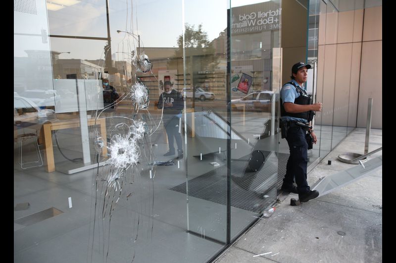 chicago cop standing outside business after august 2020 looting