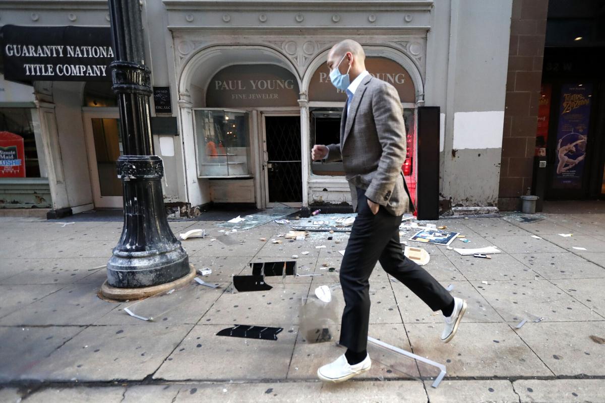 man walking past jewelry store after august 2020 looting in chicago