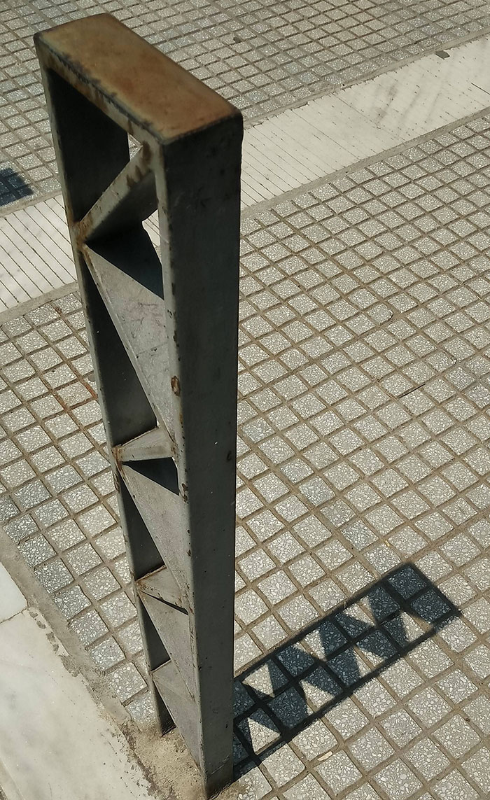 statue's shadow lining up with bricks