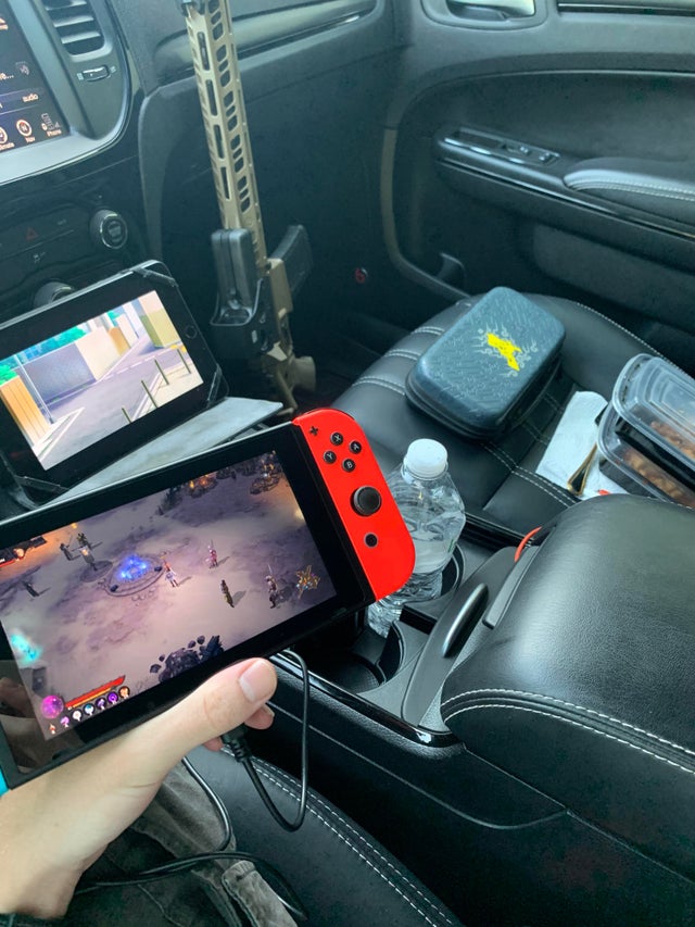 gaming setup in a car with an assault rifle