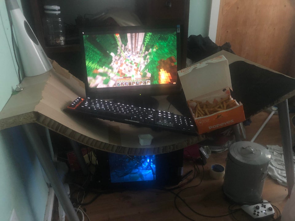 gaming setup on a sagging broken desk