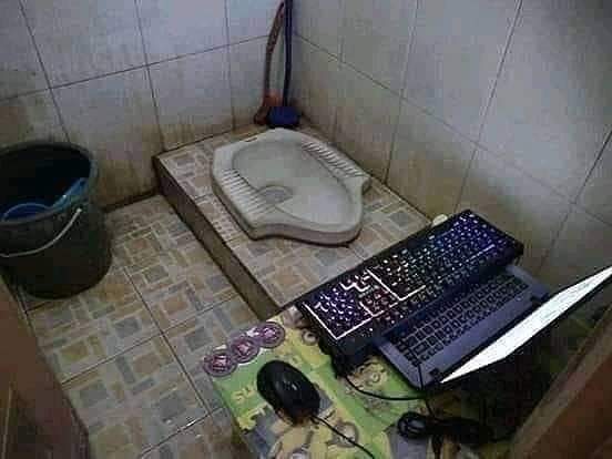 gaming setup in front of a toilet