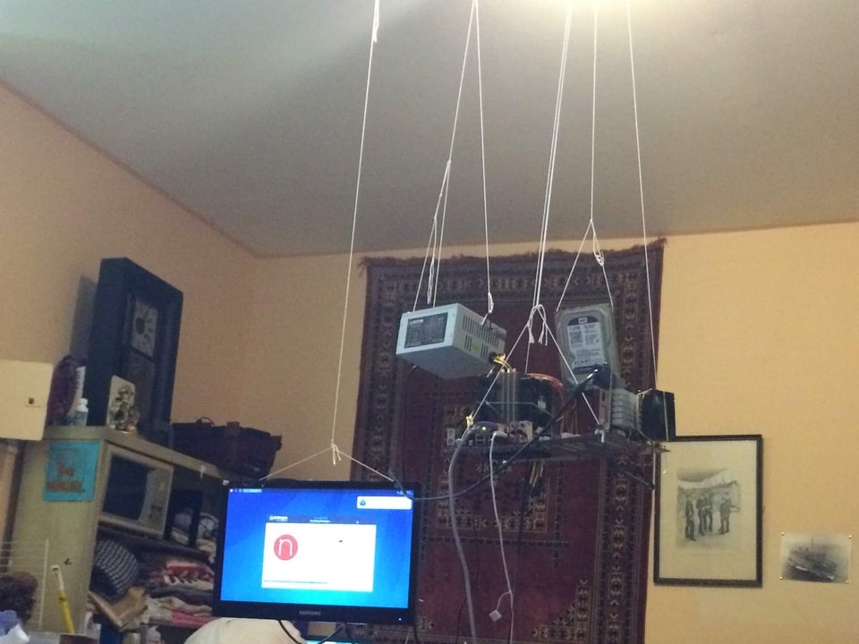 computer pc gaming setup hanging from ceiling by strings