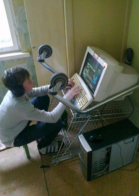 kid playing pc games on computer inside shopping cart