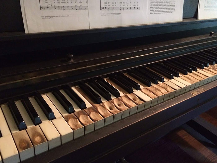 This piano's wear tells the story of how it was played.