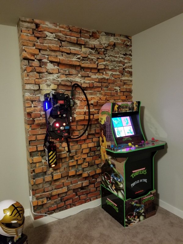 Perfect addition to a man cave or gaming room, an arcade machine and Ghost Busters Proton Pack.
