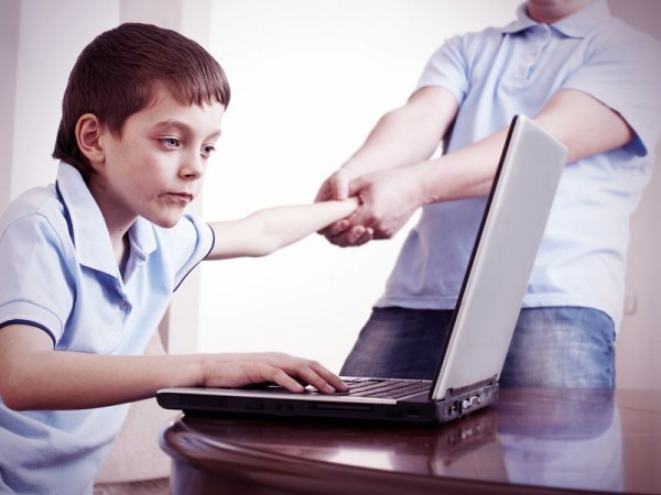 kid can't be dragged away from his laptop