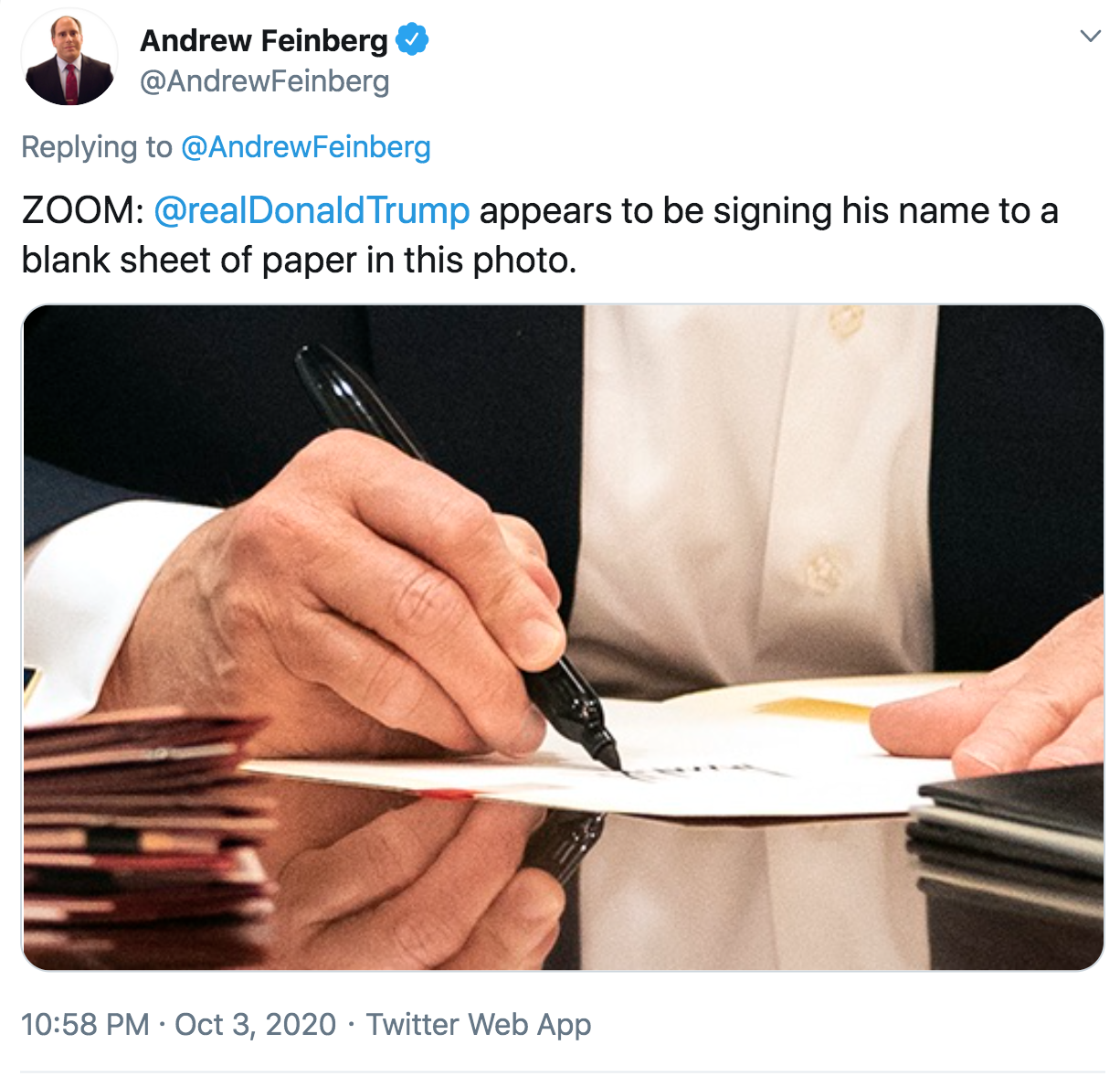 communication - Andrew Feinberg Zoom Trump appears to be signing his name to a blank sheet of paper in this photo. . Twitter Web App