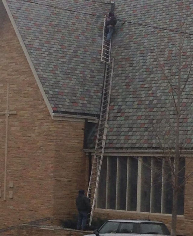 funny safety workplace fails - man stacking way too many ladders to climb roof