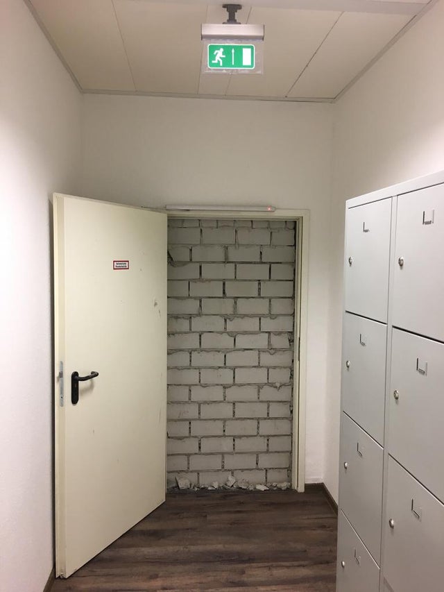 funny safety workplace fails - emergency door opens to brick wall