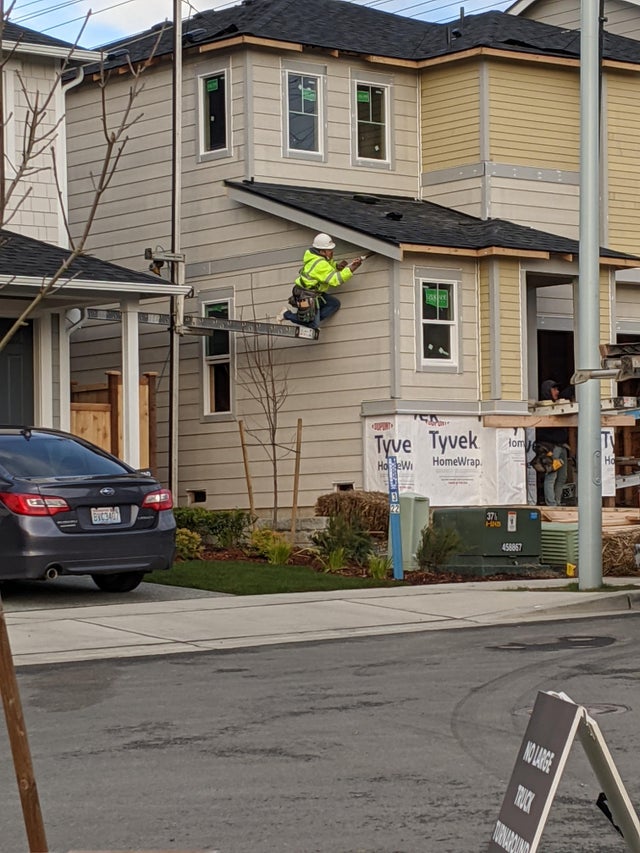 funny safety workplace fails - construction worker hanging off ladder