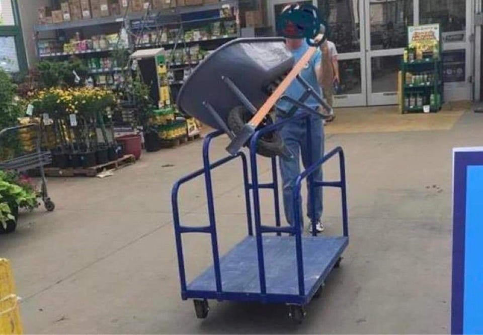 funny pics - woman carrying wheelbarrow on wheeled cart