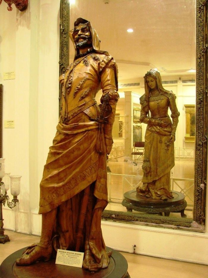 The two-sided statue of mephistopheles and margaretta (19th century) At the salar jung museum in india. The sculpture is carved out of a single log of sycamore wood. Artist unknown