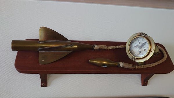  Found in a house along with lots of old maritime artifacts. What is it called and how was it used? A: Knot gauge/ speed log. Basically a boat speedometer. The propeller looking object is in the water, spinning as the boat moves, the rope spins and moves the dial, letting you know the speed as indicated on the dial. ( the rope length can be varied to a certain extent ). P.S some antique ones are worth good money.