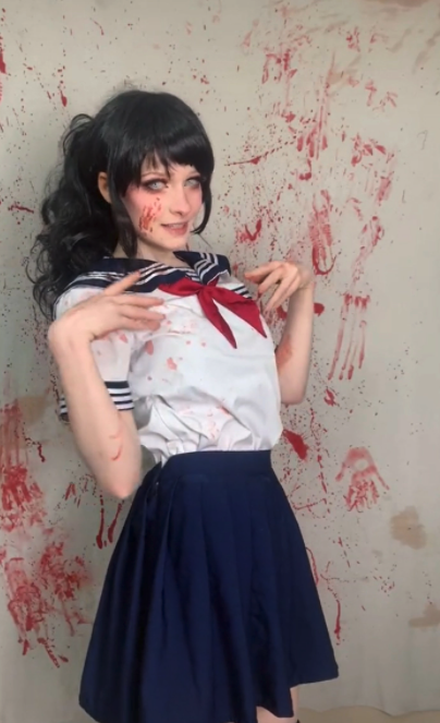 Yandere Freak Manslaughter - cosplay teen standing infront of a wall covered in blood