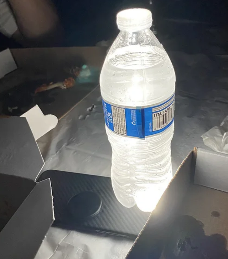 A bottle of water can be set on top of a flashlight or your phones  flashlight to significantly increase the brightness.