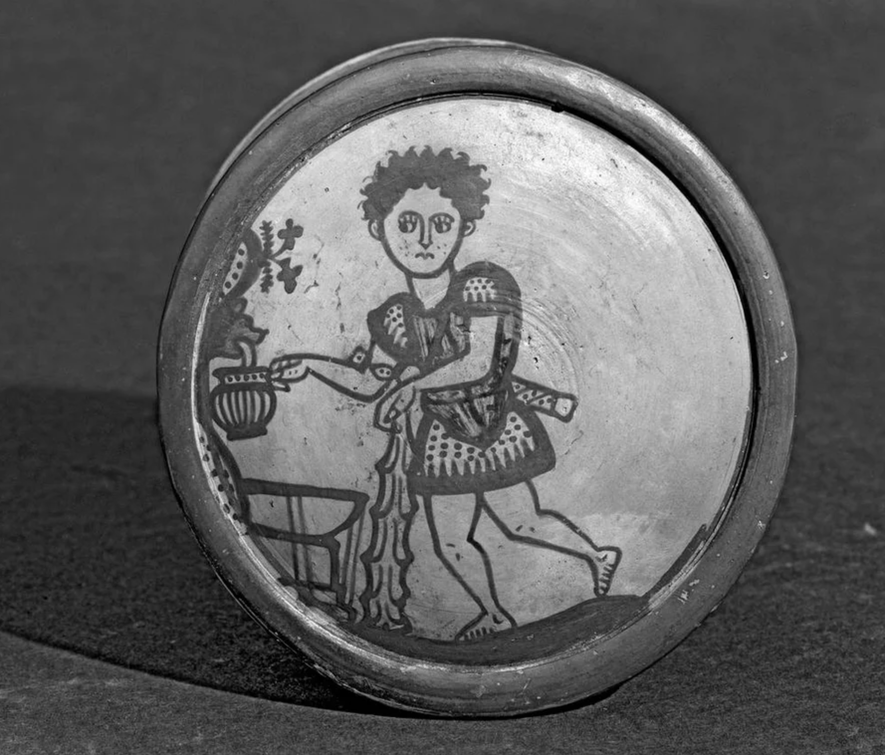 fascinating artifacts - This ancient Greek cosmetic box lid has a drawing of Herakles getting water from a fountain. 450 - 400 BC.