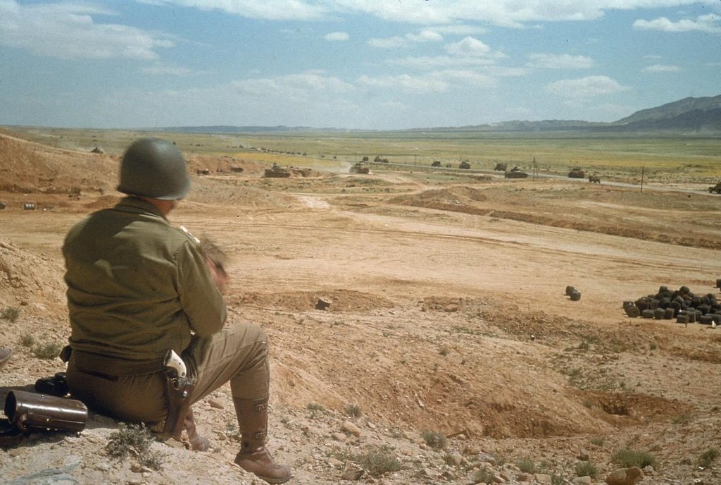 General George S. Patton watches his troops advance across the El Guettar Valley, Tunisia – March 1943