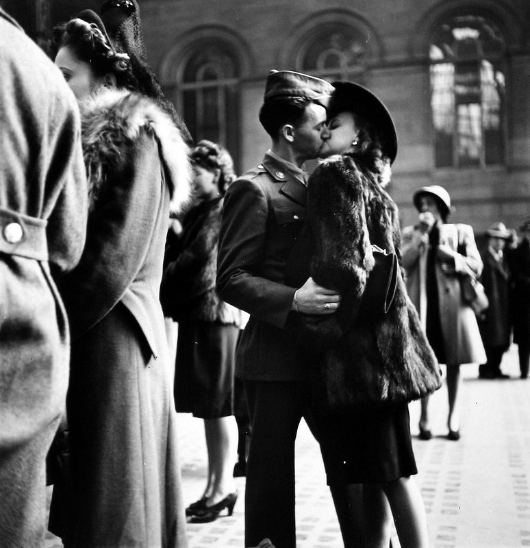 A couple in Penn Station sharing farewell kiss before he ships off to war during WWII, New York, 1943