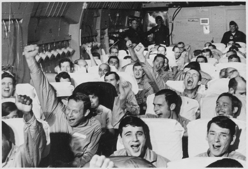 American servicemen, former prisoners of war, are cheering as their aircraft takes off from an airfield near Hanoi as part of Operation Homecoming, 1973