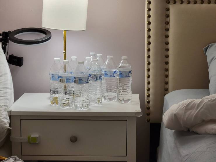 "My wife's bedside table. You literally have to get up and leave  the room to get another bottle so why not get rid of some of the empties?"