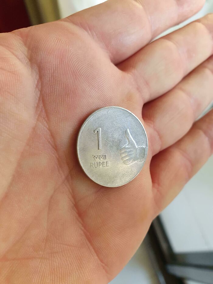 The indian 1 rupee coin just has a dude giving a thumbs up on it.