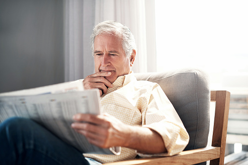 heroes become the villain - man reading a newspaper - 1