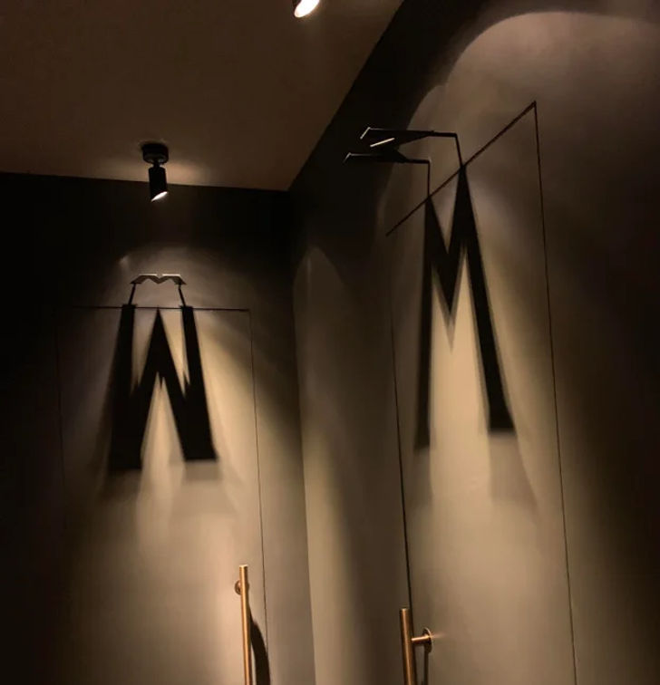 This restaurant uses shadows to show which restrooms are for men and women.