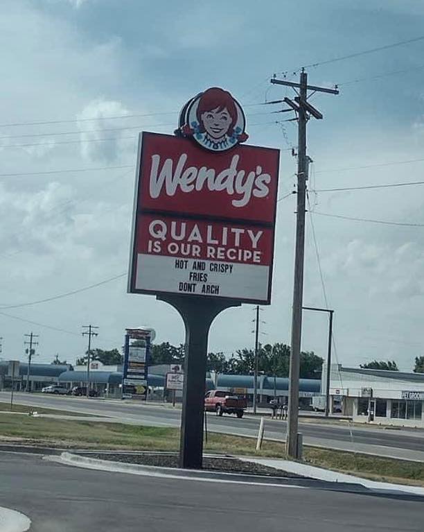 Fast food sign war - street sign - Wendy's Quality Is Our Recipe Hot And Crispy Fries Dont Arch th Pet Groom