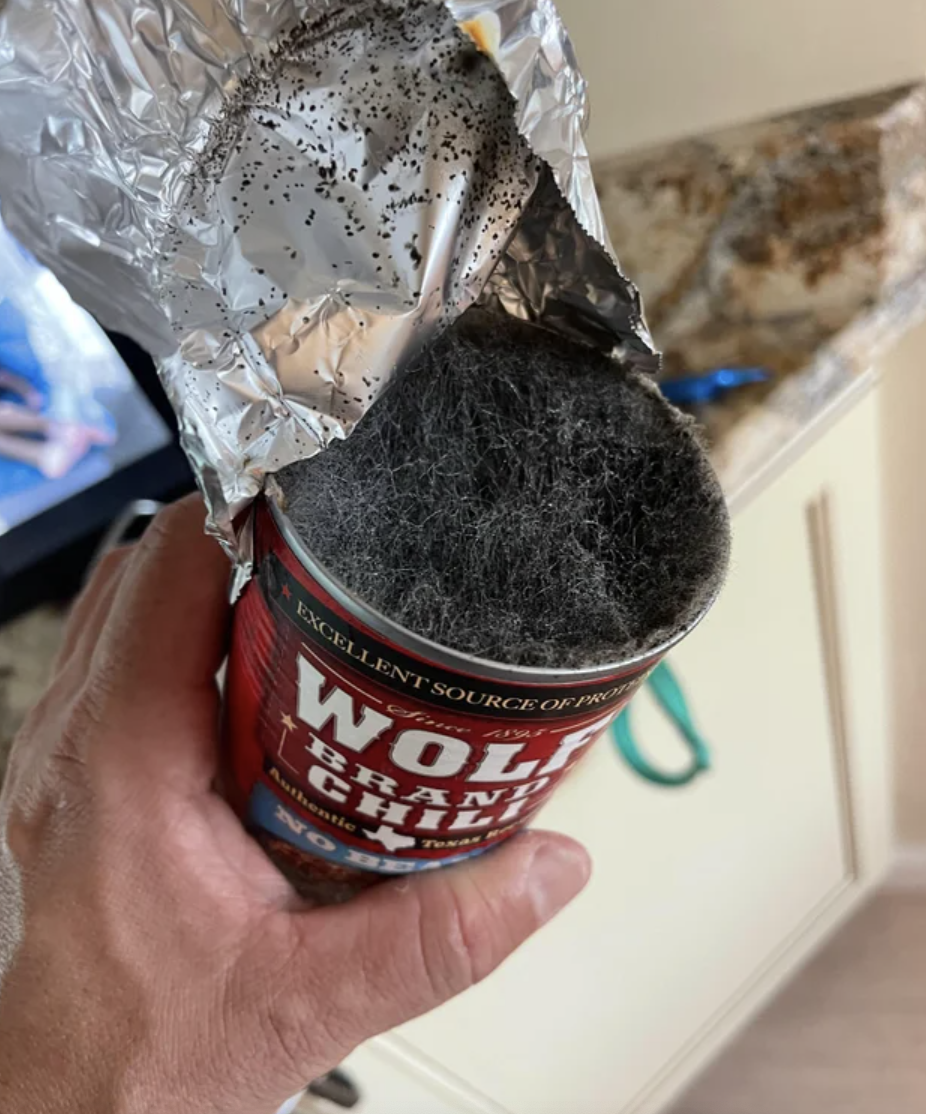 Forgot about a can of wolf brand chili in back of fridge and the mold growing looks like wolf hair.