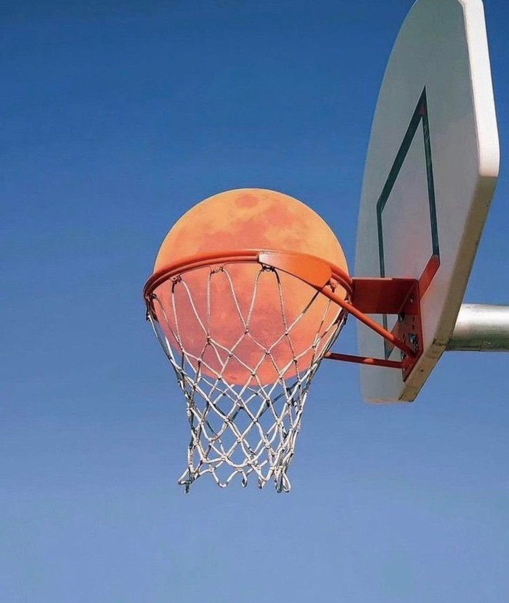 "Not only was the moon HUGE, but I caught it at just the right time / angle to look like its going in the hoop".