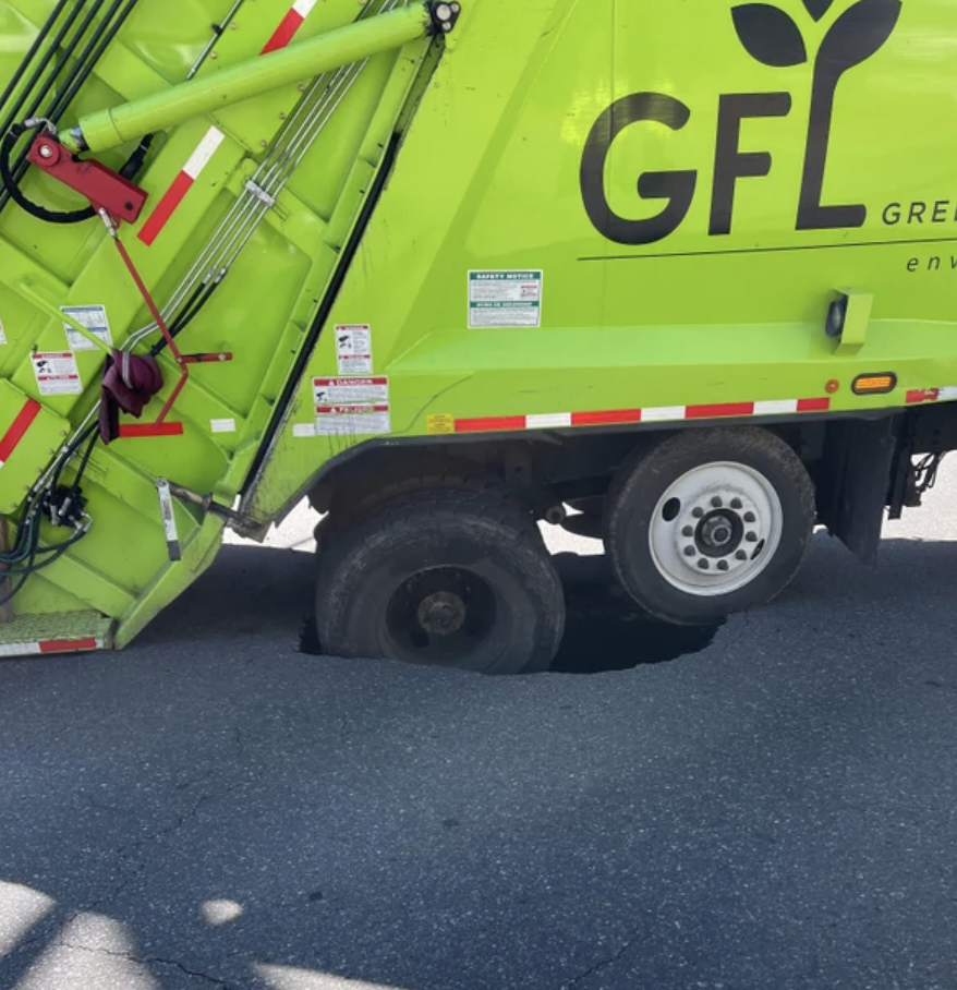 Garbage truck fell into a sinkhole.