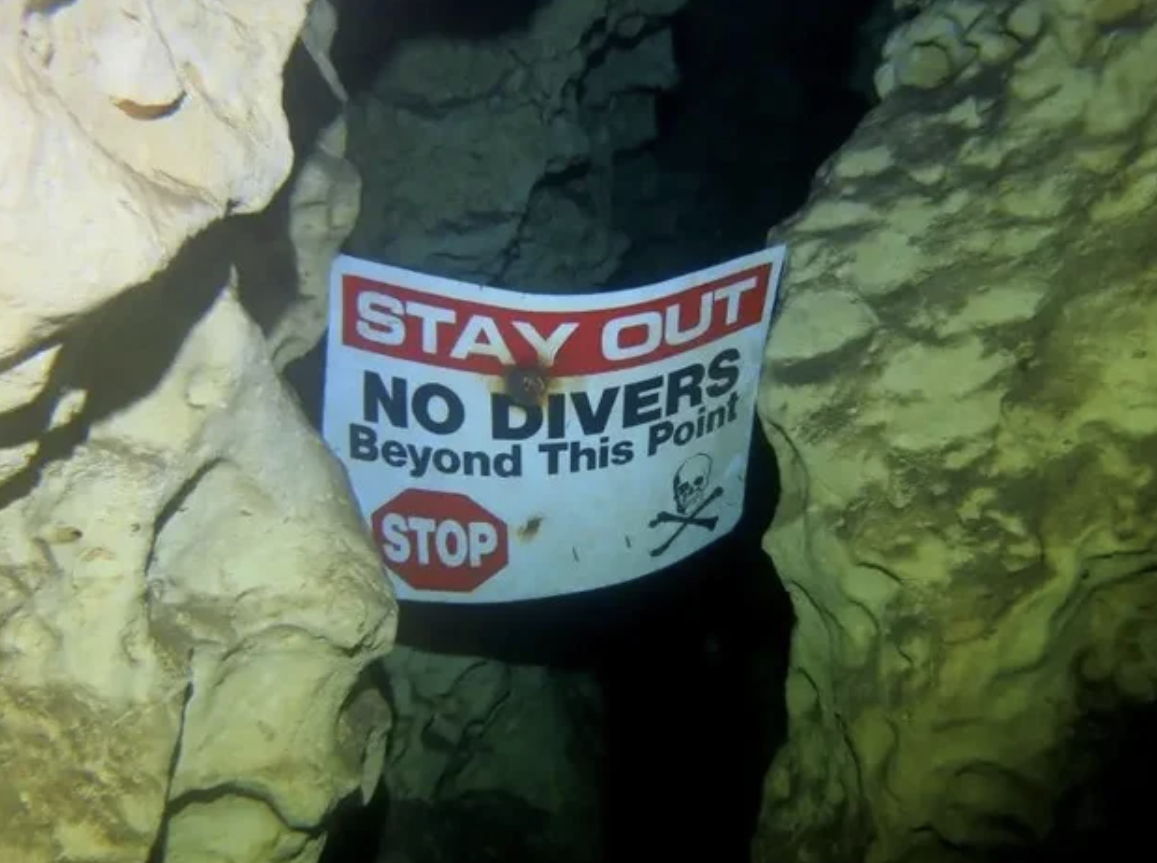 fascinating and horrifying pictures - underwater cave sign - Stay Out No Divers Beyond This Point Stop