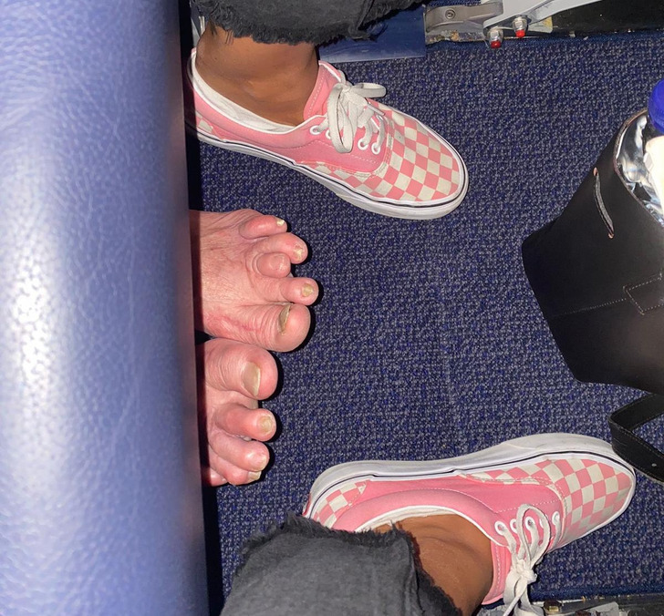 people having a bad day - feet under airplane seat