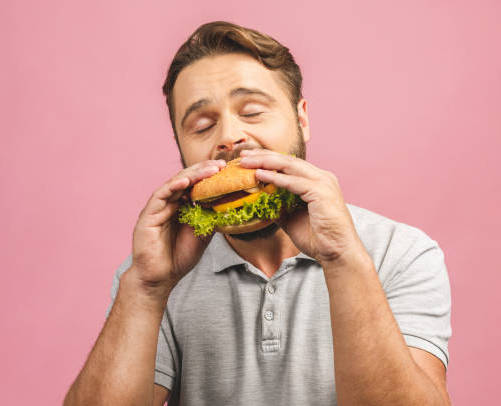 harmless pranks that mess with people - stock image eating burger -