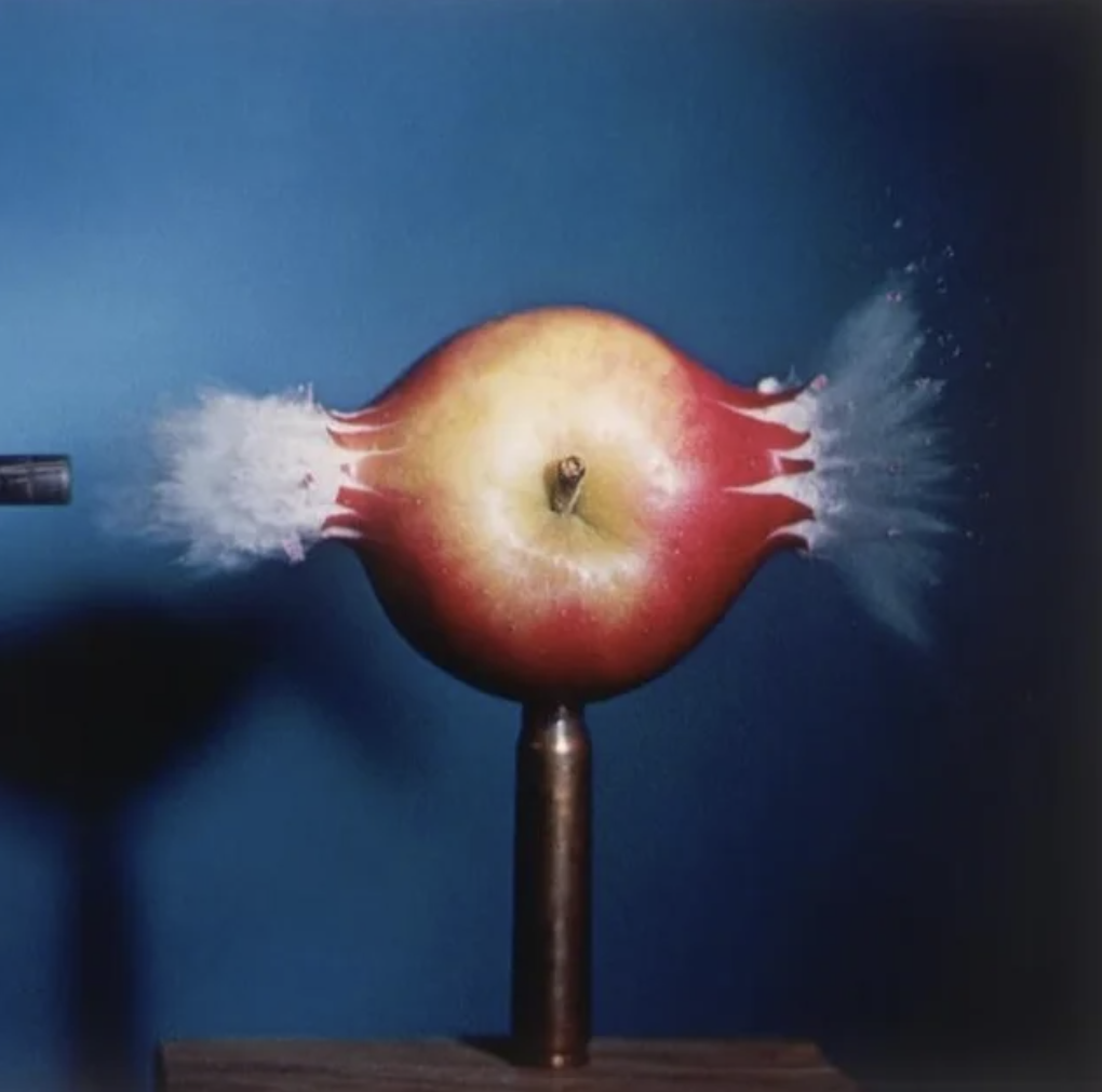 .30 caliber bullet going through an apple.