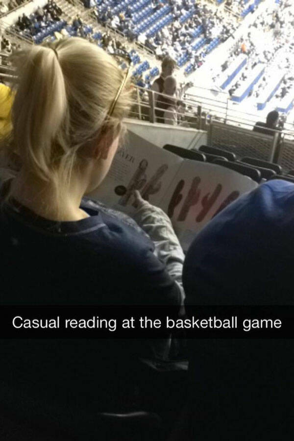 photo caption - Ver Casual reading at the basketball game