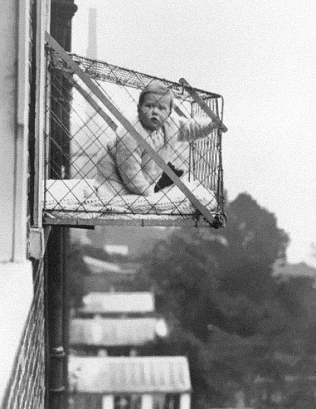 In the 1930's, apartments had baby cages so that they could get some fresh air.