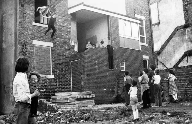 Kids playing on mattresses in England, 1981.